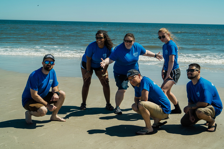 A handful of the Wonders of Wildlife staff members posing playfully for a photo.