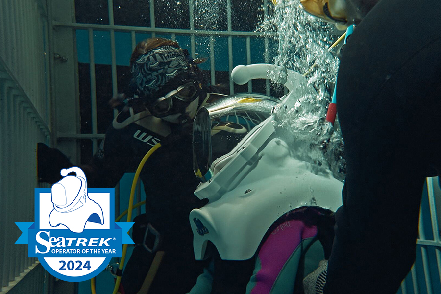 A pair of trained Wonders of Wildlife divers assist a guest with Cerebral Palsy with an Adaptive Dive in the Out To Sea exhibit.